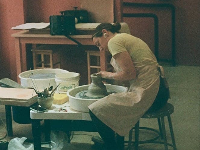 Chloe Kobernuss at the wheel in the studio, shaping a piece by hand